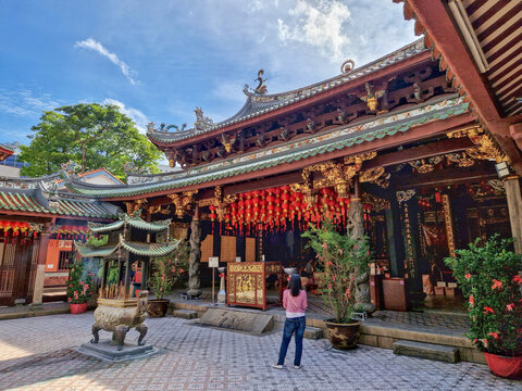 Exterior view of Thian Hock Keng temple in Singapore, traditional architecture and incense burner and roofline.