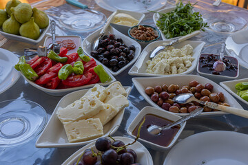 Turkish breakfast table. Cheese, Butter, Olives, Tomato, Honey, Jam, Turkish bagel (Crispy), Walnuts, Cucumber, Omelet.