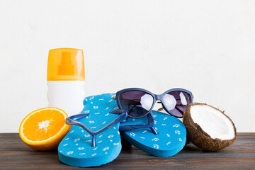 Top view composition of flip flops placed with beach accessories perspective view on table...