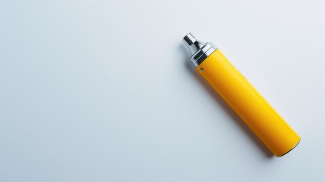 Modern smoking device in yellow on white background for vaping and nicotine viewed from above