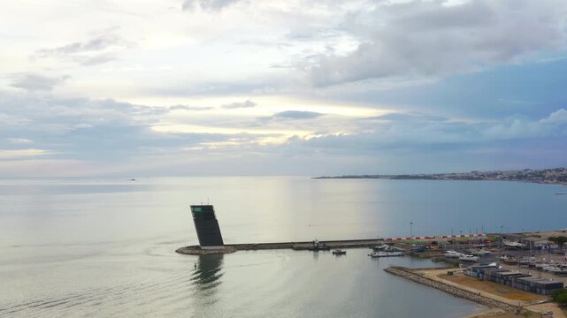 Torre VTS de Lisboa - VTS Vessel Traffic System tower Centre for Coordination and Control of Maritime Traffic and Safety of Lisbon. Aerial drone view Evening time