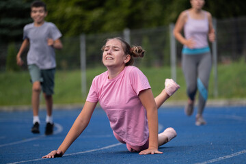 girl runs, runner falls, teenager falls, children's sports, runner, family gets involved in sports, workout, warm-up, girl runs, woman runs, sports, treadmill