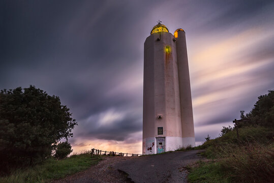 Sunset with the sky loaded with storm clouds at the Gorliz lighthouse, Bizkaia