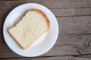Breakfast of sliced bread on wood background