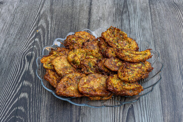 Zucchini fries or Latkes made with grated zucchini, eggs, flour, and Turkish yoghurt.