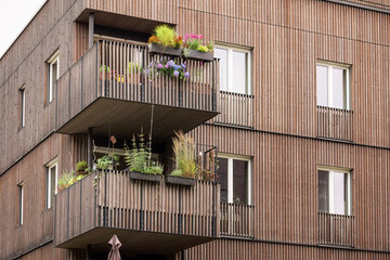 Wooden Facade of Modern Building Apartments Design. Vertical Wooden Lamella Facade of High rise Multifamily Building. Modern Wooden House Balcony. © Maryana