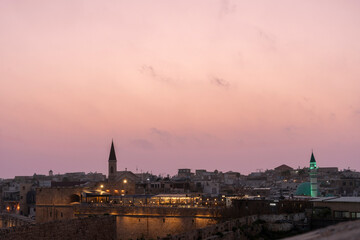 Beautiful Evening Sky Over Coastal City With Historic Buildings And Lights