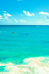 The sea at Tulum Mexico. December 2021. This was during a hot day during the Covid 19 pandemic. The Beautiful blue sky contrasts against the turquoise Caribbean sea. 