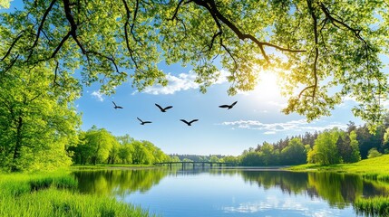 Obraz premium A tranquil lake reflects the vibrant green landscape and blue sky, with birds soaring above, creating a peaceful morning atmosphere in nature