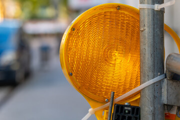 yellow traffic light is on a pole