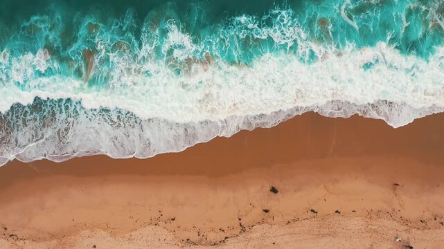 top view Beautiful topical beach with white sand. Top view empty and clean beach. Waves crashing beach from above. With people walk and relax on the beach
