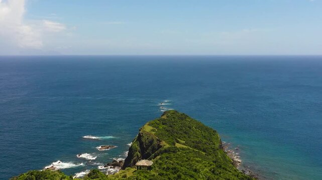 Tropical island cape and blue ocean. Cape Engano. Palaui Island. Santa Ana Philippines.