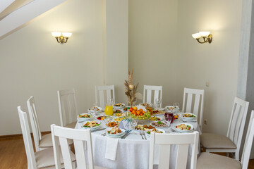 Wedding banquet in restaurant, covered round table for guests