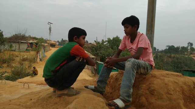 two rohingya kid siting and talking