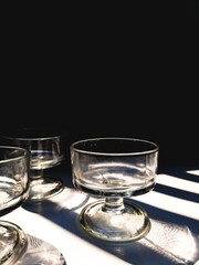 Aesthetic of transparent glasses for drink events with lines of sun shadow and glare on isolated background