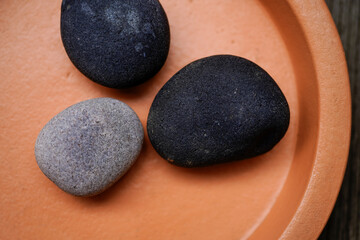 3 natural stones on a fuzz peach ceramic plant coaster