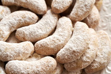 Close up of homemade Christmas cookies called Kipferl or vanilla crescents coated in sugar