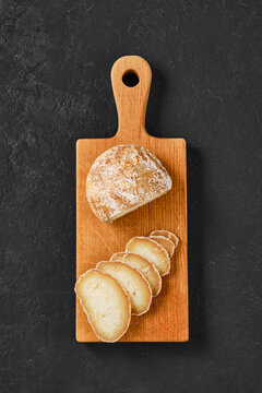 Overhead view of chopping board with traditional Georgian cheese Dambalkhacho