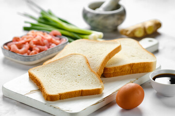 Slices of bread for toasts and ingredients on a table