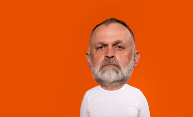 Portrait Of Middle-Aged Man With Short Hair And Beard Against Vibrant Orange Background