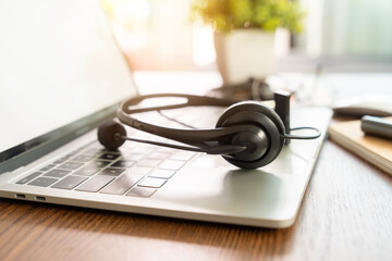 A work desk with headphones placed on it