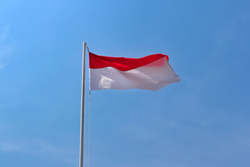 waving indonesia flag with sky background. Waving flag for celebrate indonesia independence day. Waving indonesia flag with red and white color