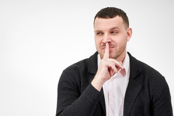 Man saying hush and be quiet with finger on lips gesture