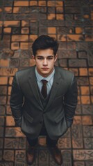 Handsome Young Man in Stylish Suit Standing on Patterned Brick Pavement