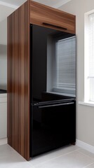 Fototapeta premium A contemporary kitchen showcases a black refrigerator and various stylish appliances set against a minimalist design with wooden cabinetry and large windows