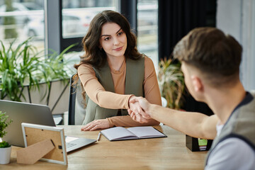 Good-looking colleagues shake hands while navigating a challenging situation.