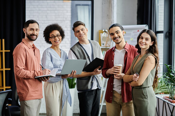 Colleagues engage in discussion while dressed elegantly and casually in a bright office.