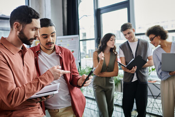 Team members engage in conversation amidst transitional workplace dynamics.