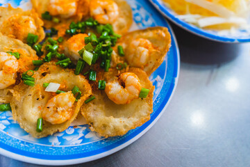 Vietnamese tiny shrimp pancake- Banh Khot Vung Tau. Vietnamese local cuisine. Served with vegetables. Selective focus