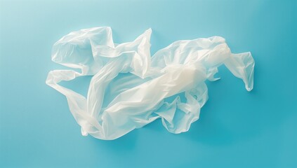 Crumpled white plastic bag on a vibrant blue background. Concepts of environmental waste, pollution, and sustainability.