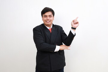 Young employee businessman corporate lawyer point index finger aside on empty space area mock up isolated on white background studio