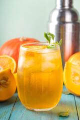 Pumpkin and orange autumn lemonade drink. Sweet tasty drink for fall Thanksgiving party, tasty fruit punch or margarita cocktail