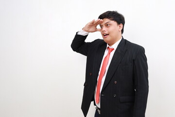 Young asian successful employee businessman hold hand at forehead look far away distance isolated on white background