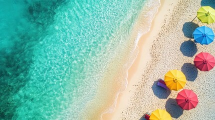Obraz premium Beautiful aerial view of a tropical beach with colorful umbrellas along the shore, inviting relaxation and summer vibes.