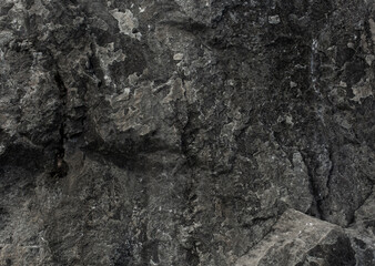 Black yellow rock texture. Mountain surface. Close-up. Gray stone background with copy space for design. Wide banner. Panoramic.