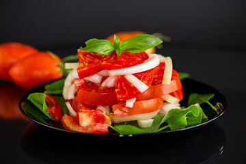 salad of fresh red tomatoes with onions