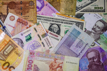 Multi currency background. Euro, american dollars, ukrainian hryvnias, egyptian pounds, russian roubles