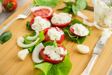 tomato wedges with cottage cheese filling and garlic, spicy appetizer