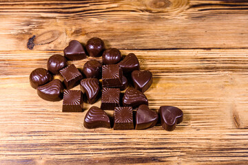 Heap of chocolate candies on a wooden table