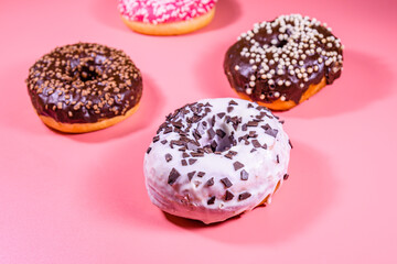 Fresh glazed donuts isolated on a pink background