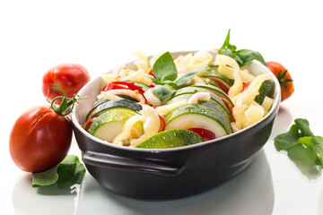 raw zucchini and tomatoes sliced and prepared for baking in a ceramic dish, vegetable appetizer