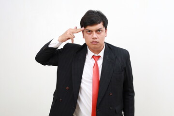 Handsome businessman doing standing while showing gun gesture