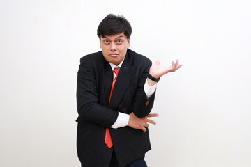 Displeased confused young asian businessman Spreading hands isolated on white wall background