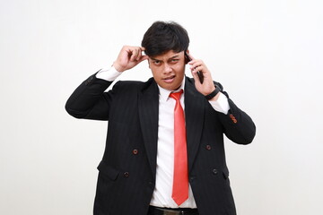 Stressed confused asian businessman having a phone call. Efficiency, planning and stress management...