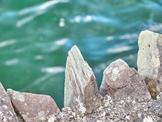 Natural stones and sea waves close view background