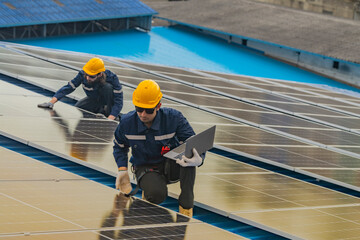 engineer man inspects construction of solar cell panel or photovoltaic cell by electronic device....